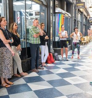 a group of people standing on a checkered floor