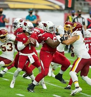 a group of football players running on a field
