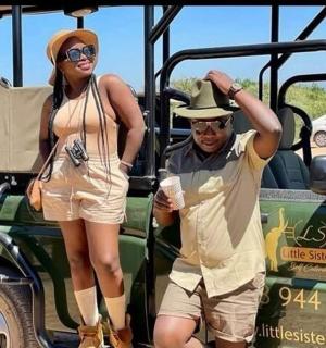 a man and a woman standing in front of a bus