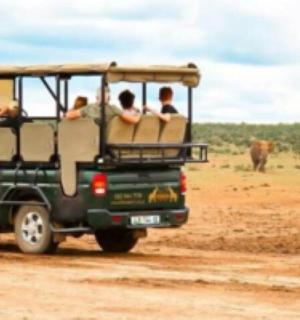 a group of people in a jeep on a dirt road