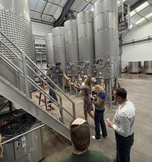 a group of people standing around in a factory