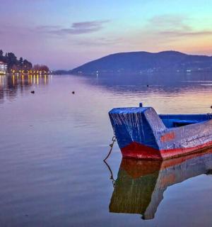 a boat sitting in the middle of a body of water