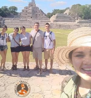 a group of people standing in front of a pyramid