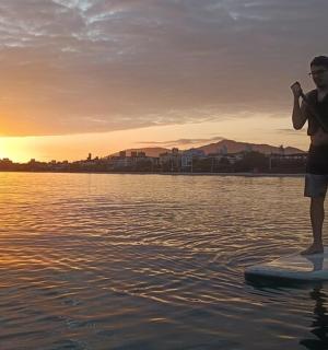 a man standing on a paddle board in the water