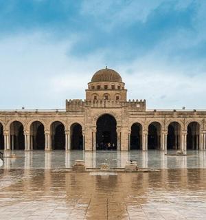a large building with water in front of it