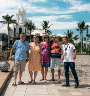 a group of people standing in front of a resort