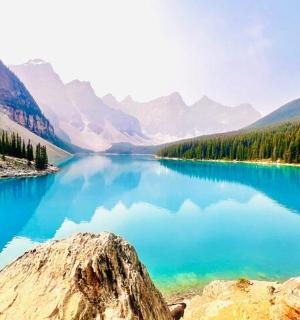a view of a blue lake with trees and mountains