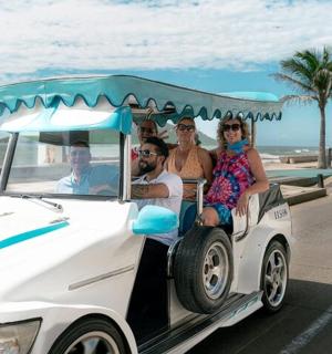 a group of people riding in a golf cart