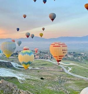 a bunch of hot air balloons flying in the sky