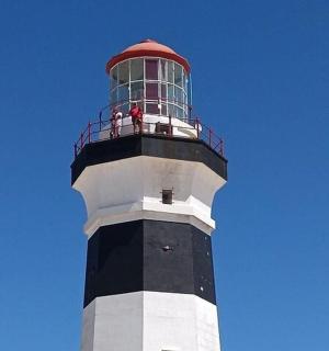 a lighthouse with people standing on top of it