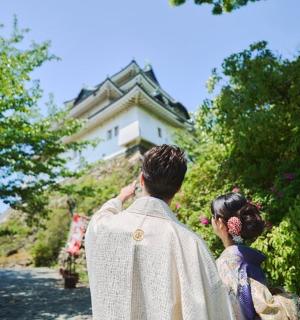 a man and a woman standing in front of a house