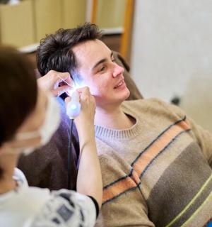 a woman sitting next to a man on a couch