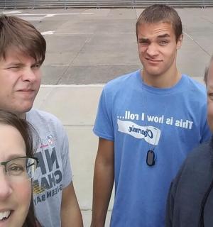 a group of four people posing for a picture