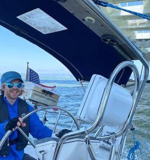 a man sitting on a boat in the water