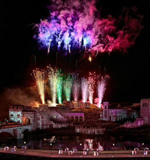 a fireworks display in front of a castle at night