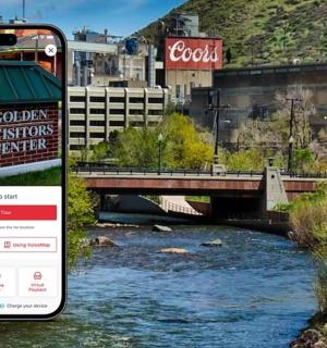 a cell phone taking a picture of a river with a bridge