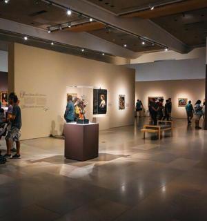 a group of people standing in an art exhibit