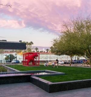 a park with a red structure in a city