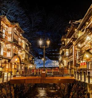 a bridge over a canal in a city at night