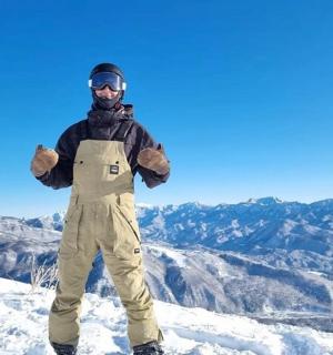 a man standing on top of a snow covered mountain