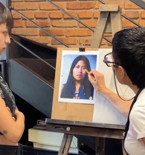 一名男子正在画一名女子的画像