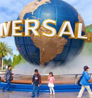 a group of people standing in front of the word travel
