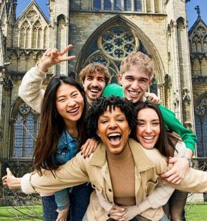 a group of people posing in front of a cathedral