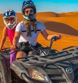 two people on a atv in the desert