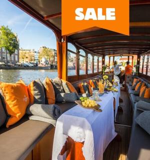 a boat with a table with an orange sale sign on it