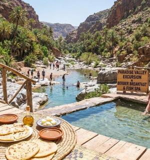 a group of people sitting at a table in a swimming pool