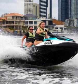 two people riding on a jet ski in the water