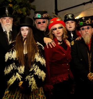 a group of people in costumes posing for a picture
