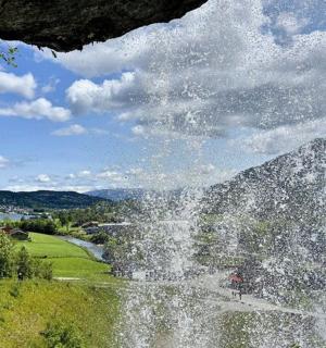 a water fountain in front of a mountain