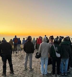 a large group of people standing on top of a mountain