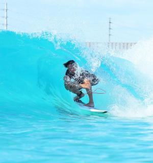 a man riding a wave on a surfboard in the ocean