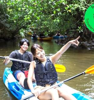 two people in a kayak on a river with a frisbee