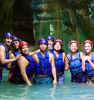 a group of people in the water on a raft
