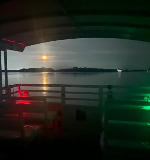 a boat in the water with the sun setting