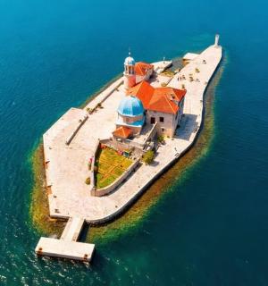 an island in the water with a lighthouse on it