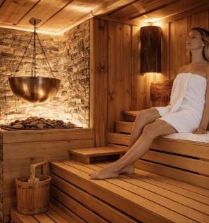 a woman sitting on the edge of a sauna