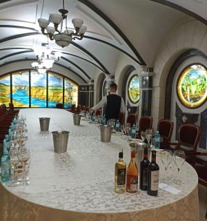 a table in a room with wine bottles and glasses