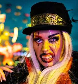 a woman dressed up as a clown with makeup