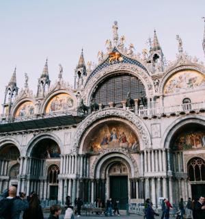 a large building with people walking in front of it