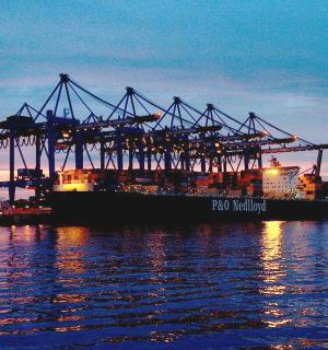 ein großes Containerschiff im Wasser in der Abenddämmerung