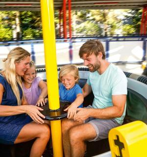 a group of people sitting on a roller coaster