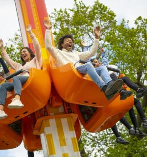 a group of people riding on a roller coaster