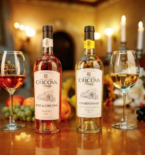 two bottles of wine sitting on a table with wine glasses