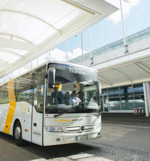 a white bus parked under a building