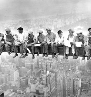 a group of people sitting on top of a building