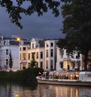 a boat on a river in front of a building